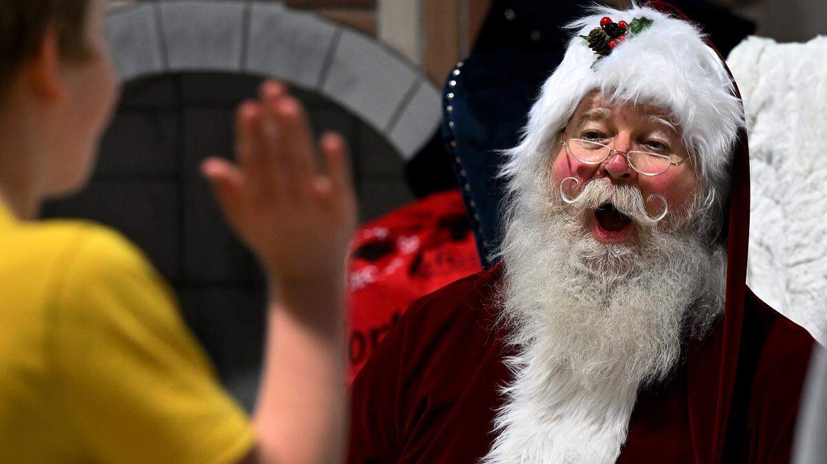 Santa is delighted by a child at the 38th annual Flight to the North Pole program for children with disabilities and terminal illnesses at Feld Entertainment in Palmetto.