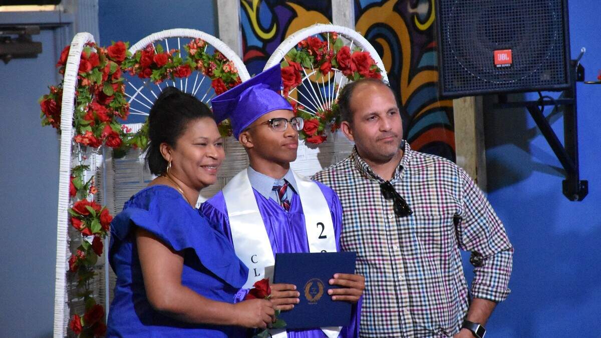 Graduate Franklin Valdez poses for a photo with his parents after receiving his degree at the Support Homeschool Activities Reaching Everyone (SHARE) Class of 2019 graduation ceremony Friday night.