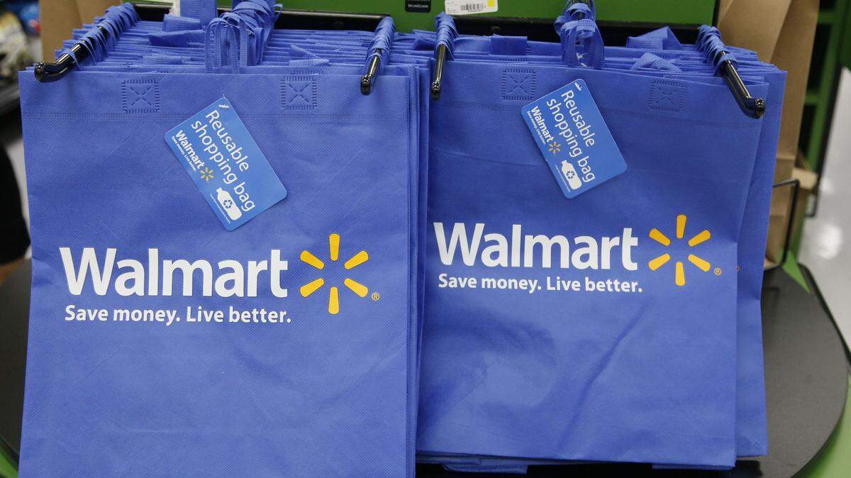 FILE - In this Thursday, Sept. 19, 2013, file photo, reusable shopping bags are offered for sale at a Wal-Mart Neighborhood Market, in the Chinatown district of Los Angeles. Wal-Mart is sharpening its attack against Amazon. The discounter says it is changing its membership-based free shipping service test to two days from three days and is charging one dollar less for the annual membership fee. Wal-Mart began testing the service in 2015 as a way to counter Amazonís highly successful Prime shipping. (AP Photo/Nick Ut, File)