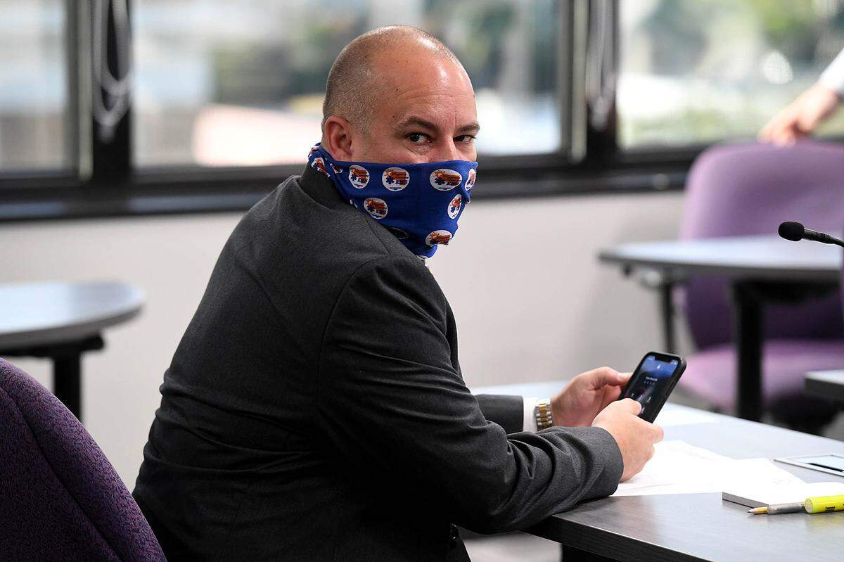 02/18/21--Bryan Kitchner, a special agent with the FDLE served subpoenas to four commissioners ahead of ThursdayÕs public work session meeting. Commissioner Kevin Van Ostenbridge picks up his phone after receiving the subpoena.