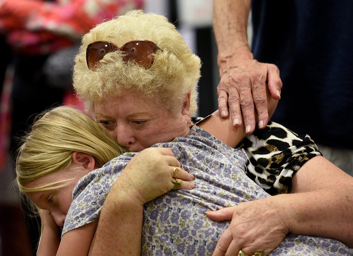 Students from Marjory Stoneman Douglas joined local student activists at a town hall meeting in Sarasota at Selby Library Wednesday. A family waits in line for the auditorium doors to open.