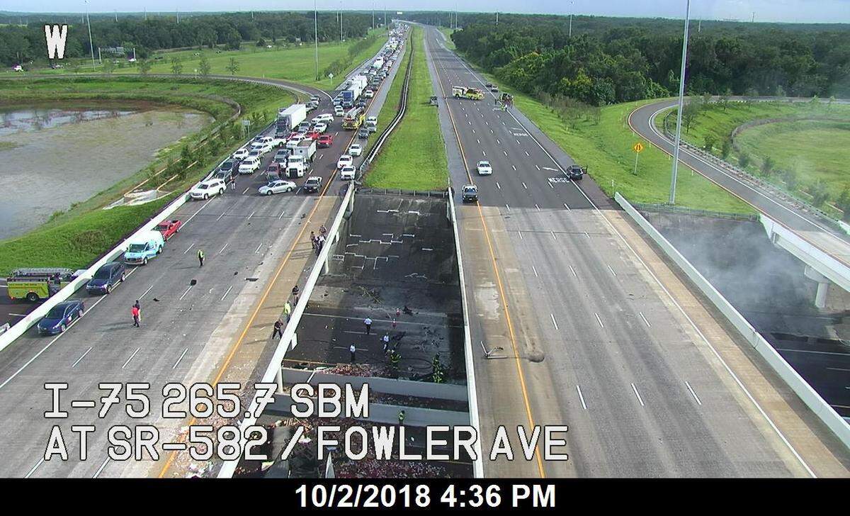 At least one person is dead and Interstate 75 in completely shut down after a tractor trailer carrying produce lost control, went through the guard rail and landed on Fowler Avenue in Hillsborough County.