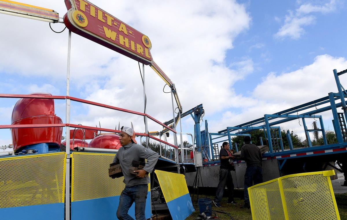 Workers get the Tilt-A-Whirl set up for the annual Manatee County Fair at the fairgrounds in Palmetto.