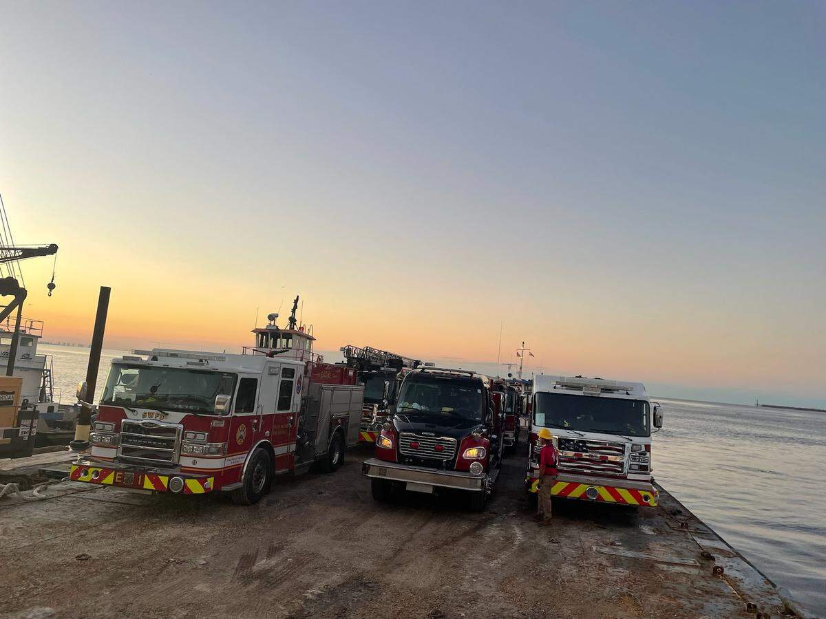 On a barge, multiple fire engines set sail for Sanibel.