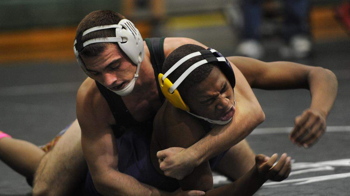 Lakewood Ranch High's Dylan Cameron wrestles Booker High's Jeffrey Phillips on Saturday at the sixth annual Mustang Duals at the Ranch. 
 GRANT JEFFERIES/Bradenton Herald