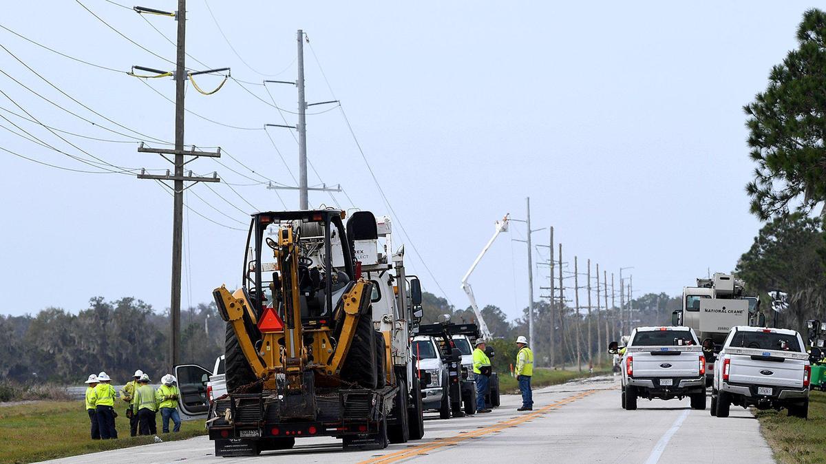 Crews work along State Road 62 between C.R. 37 and Duette Road to repair power lines downed in a strong storm leaving hundreds in Duette without power.