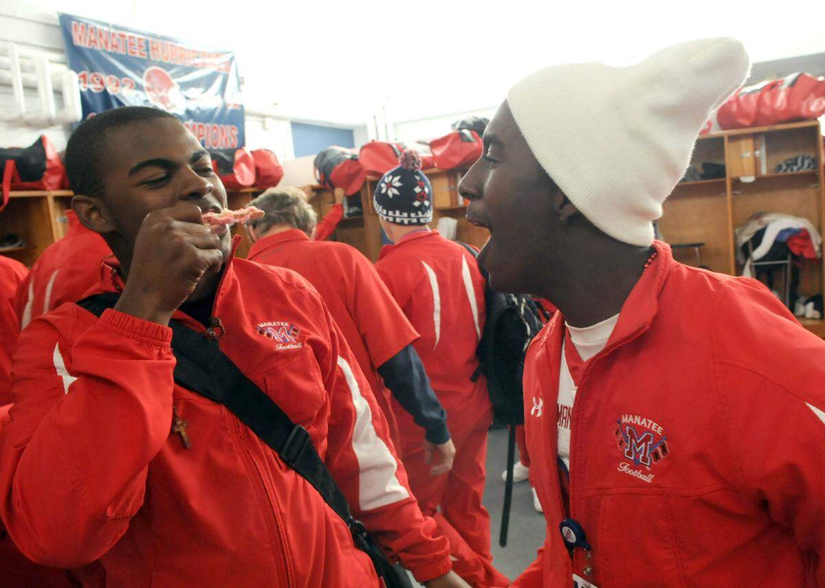 Manatee High School’s Bryan Bing and John Johnson cheer in the locker room as they prepare to travel to St. Thomas Aquinas for the Class 5A state semifinals 2010.