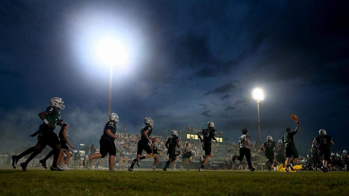 Lakewood Ranch makes their entrance through a tunnel to play Manatee at Lakewood Ranch stadium on Friday, Sept. 29, 2023.