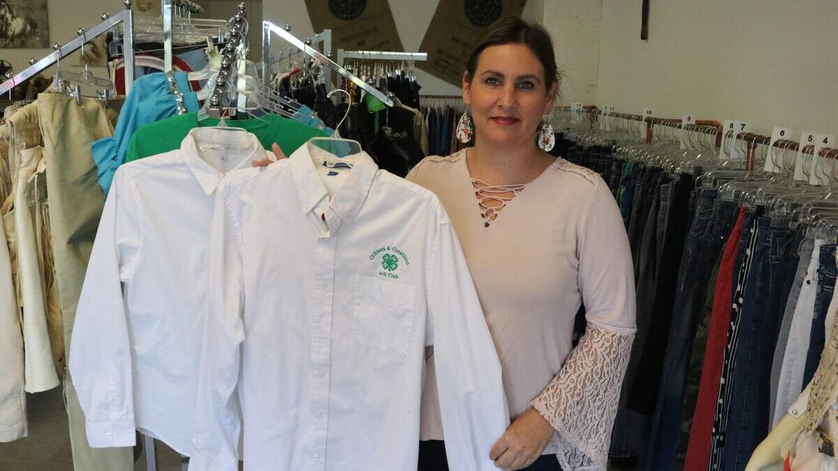 Mitsy Southerland shows one of the used 4-H Club white shirts that she has in stock at The Consignment Barn and Boutique.