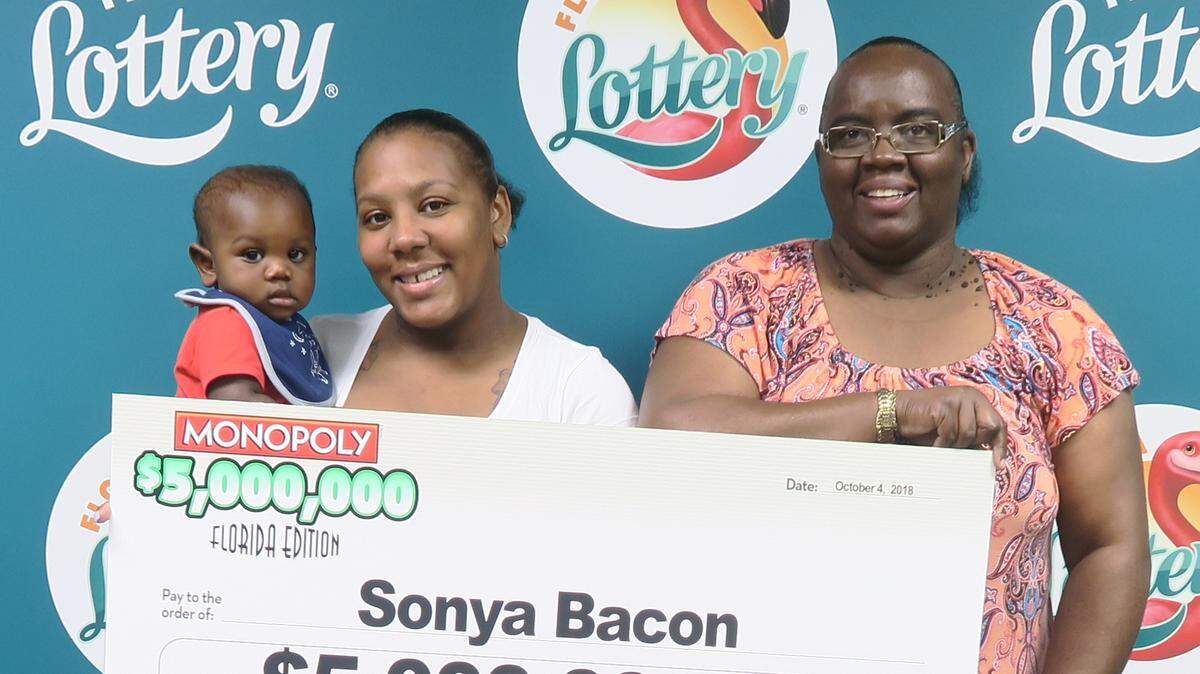Sonya Bacon, 49, of Palmetto (right), poses with her family and oversized check after claiming a $5 million top prize in the $5,000,000 MONOPOLY™ FLORIDA EDITION Scratch-Off game.