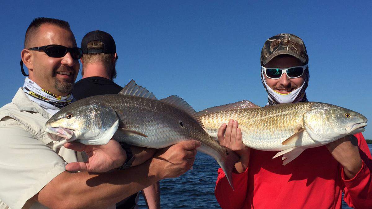 David Salapski, left, and Jeff Minch hold up a 30- and 31.5-inch redfish they caught during the 18th annual Yerrid Foundation Grand Slam Fishing Tournament on Saturday. PROVIDED PHOTO