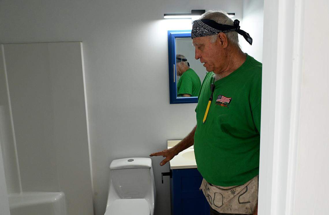 Glen Gibellina built this tiny home from three shipping containers, modifying them to create a modern-looking dwelling that he says is hurricane and soundproof. The bathroom has a fiberglass shower and the toilet goes to a septic tank.