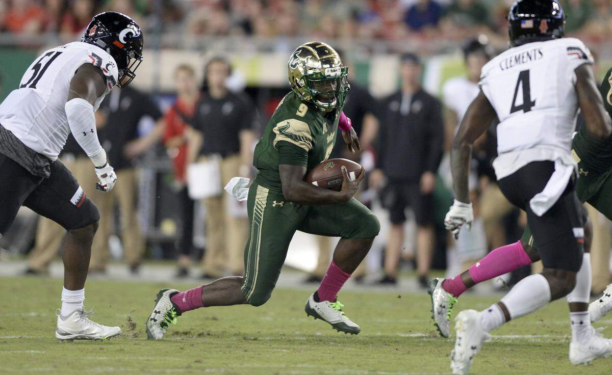 In this file photo, South Florida quarterback Quinton Flowers (9) runs during the second half of an NCAA college football game against Cincinnati Saturday, Oct. 14, 2017, in Tampa, Fla.