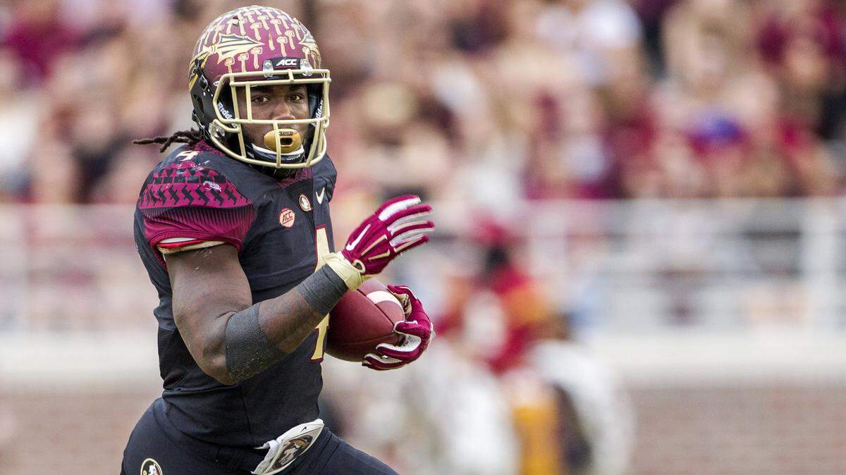 In this Nov. 25, 2015, file photo, former Florida State running back Dalvin Cook wears the alternate black uniform as he runs in for a touchdown in the first half of an NCAA college football game against Chattanooga in Tallahassee, Fla.