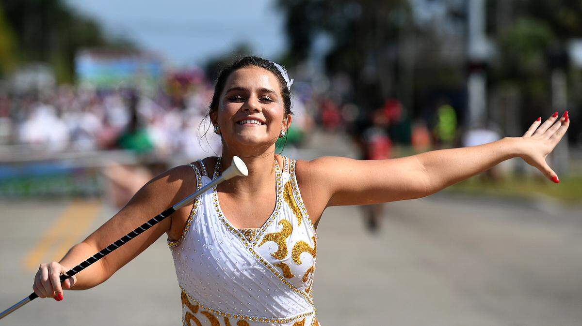 Katherine Mercer smiles while twirling and marching in the Hernando DeSoto Historical Society’s Children’s Parade on Friday, April 7, 2023 in Palmetto.