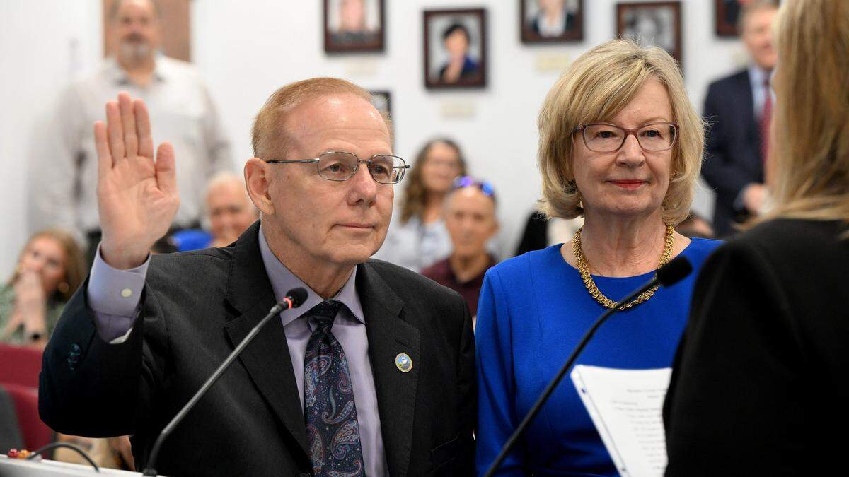 Robert McCann with wife, Rose Marie, is sworn in as Manatee County Commissioner for District 5 during a swearing-in ceremony in the chambers.
