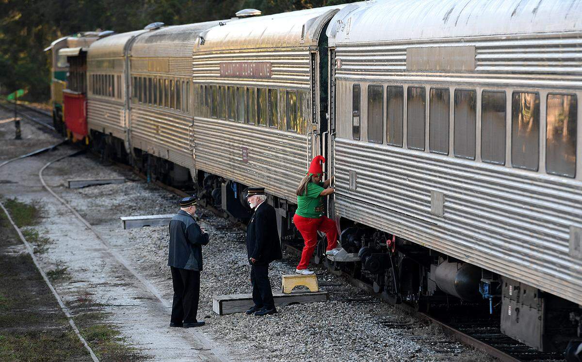 12/08/21—An elf boards the train as children and their families board the North Pole Express at the Florida Railway Museum for a trip to meet Santa at the 36th annual event for terminally ill children.