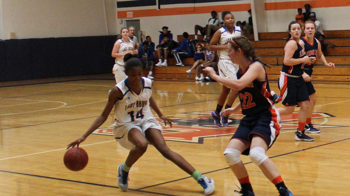 Quonnisha Orr, 14, of Bayshore High School puts on the brakes against Shannen Smith of Lemon Bay during the SmoothieKing Classic on Monday. 
 JAMES A. JONES JR./Bradenton Herald