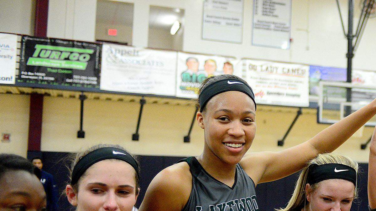 Elise Spiller (20) holds their trophy and celebrates with teammates.  The Lakewood Ranch Lady Mustangs defeated the Lady Hurricanes from Palm Harbor University High School 49-42 to claim the Class 7A Region 3 Championship at Palm Harbor University High School on Friday evening February 12, 2016. The Lady Mustangs will advance to the State Final  Four next week.
