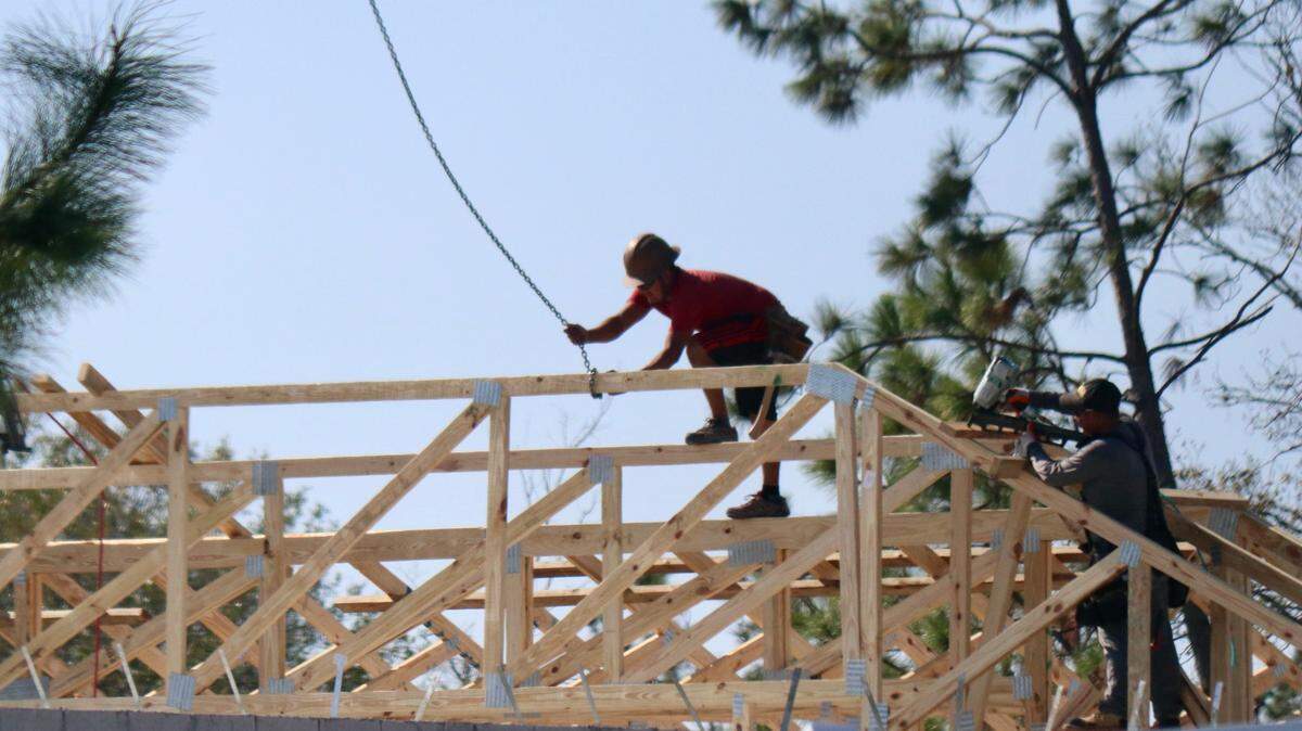 Workers attach roof trusses to a home under construction at Lakewood Ranch on Dec. 5, 2022. Lakewood Ranch remained one of Manatee County’s hottest building areas in 2022.