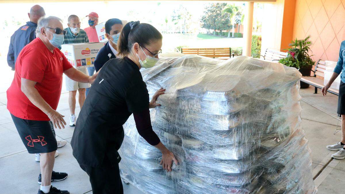 12/29/2020--Esplanade residents and hospital staff moved 920 box lunches into Lakewood Ranch Medial Center on Tuesday. The box lunches were a gift from residents of Esplanade Golf and Country Club in Lakewood Ranch.