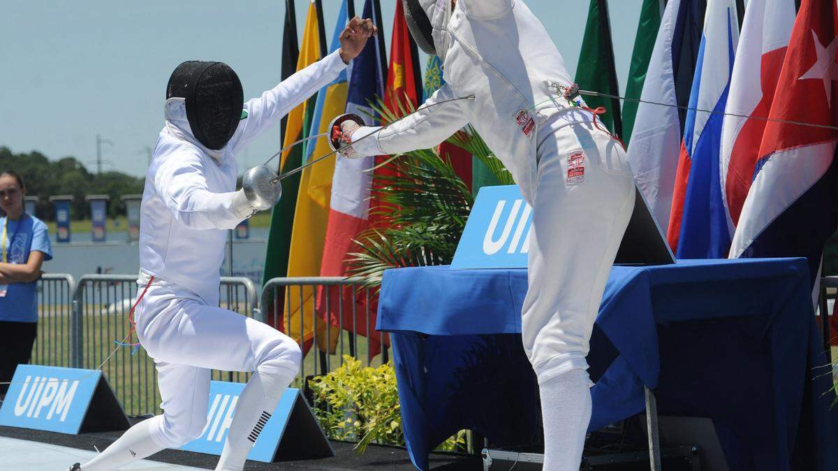 Alvaro Sandoval of Mexico and Stefan Kollner of Germany take part in the men's final fencing bonus round at the Modern Pentathlon 2016 UIPM World Cup Final on Saturday at Nathan Benderson Park in Sarasota. 
 GRANT JEFFERIES/Bradenton Herald