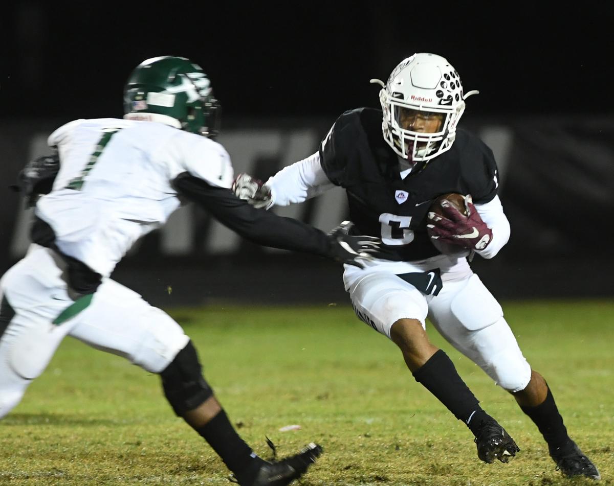 Brian Battie runs the ball during Friday night’s game at Pirate Stadium between Braden River and St. Petersburg High.