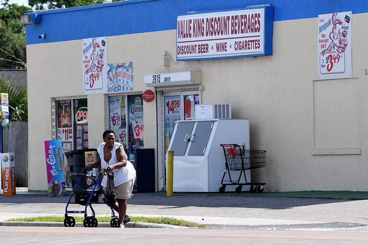A pedestrian tries to make her way safely across traffic on 14th Street West.
