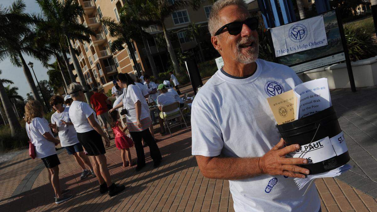 Dennis Schultz collects donations along Bradenton's Riverwalk on Saturday in the third annual St. Vincent de Paul Walk For The Poor.GRANT JEFFERIES/Bradenton Herald