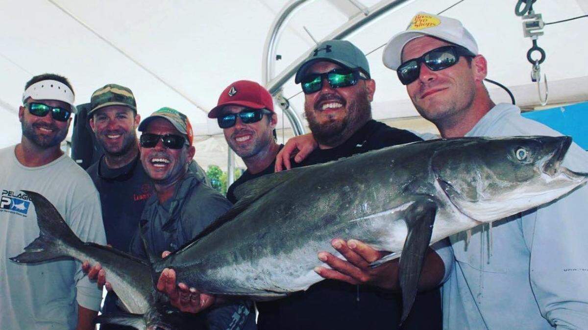 Members of the fishing team Richardson Stinton Roofing powered by Skeeter Boats pose with two cobia at a tournament.