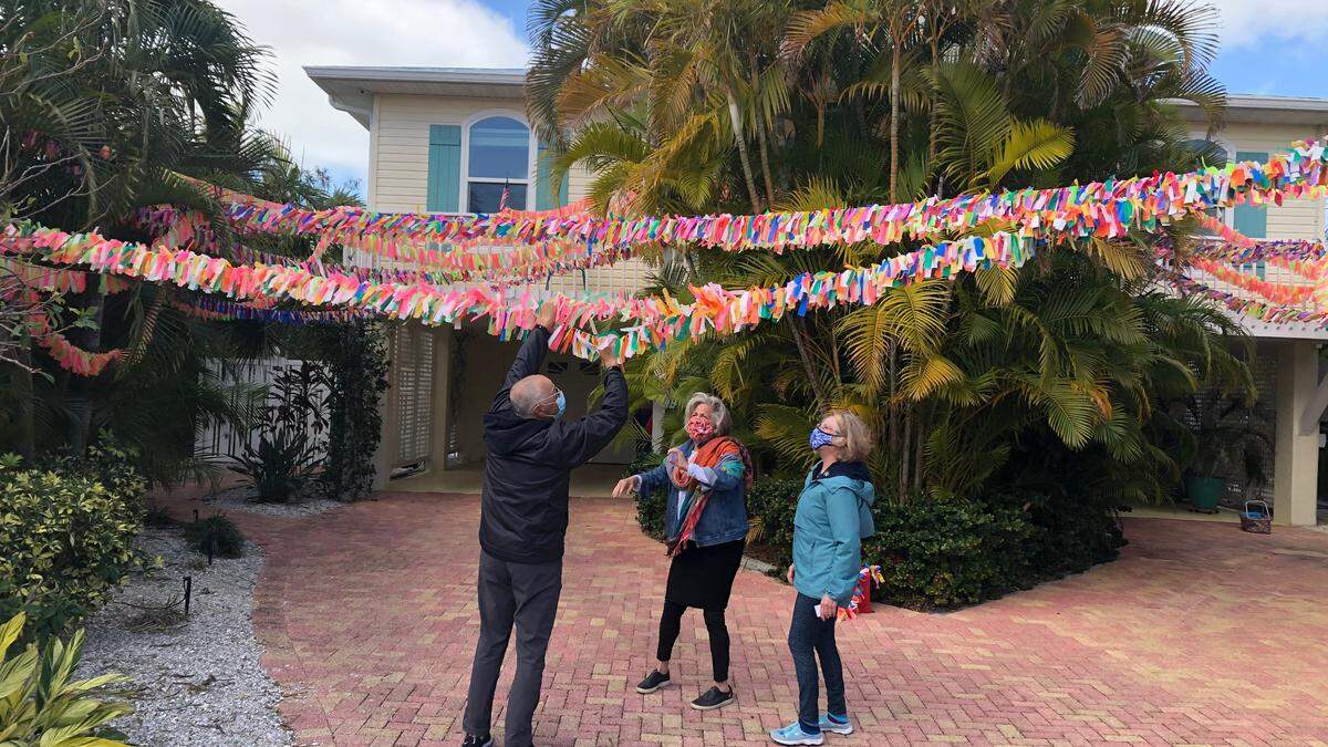 2/2/2021--Anna Maria resident Cathy Tobias plans to unfurl a memorial chain on the beach Feb. 16, commemorating the more than 26,000 Floridians who have died of COVID-19. The chain contains one ribbon for each person who has died during the pandemic and is estimated to be more than two football fields long.
