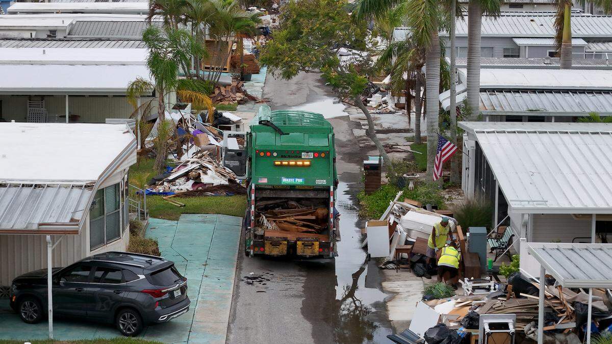 Waste Pro workers load debris left from Hurricane Helene in Sunny Shores as Hurricane Milton approaches Manatee County on Oct. 8, 2024.