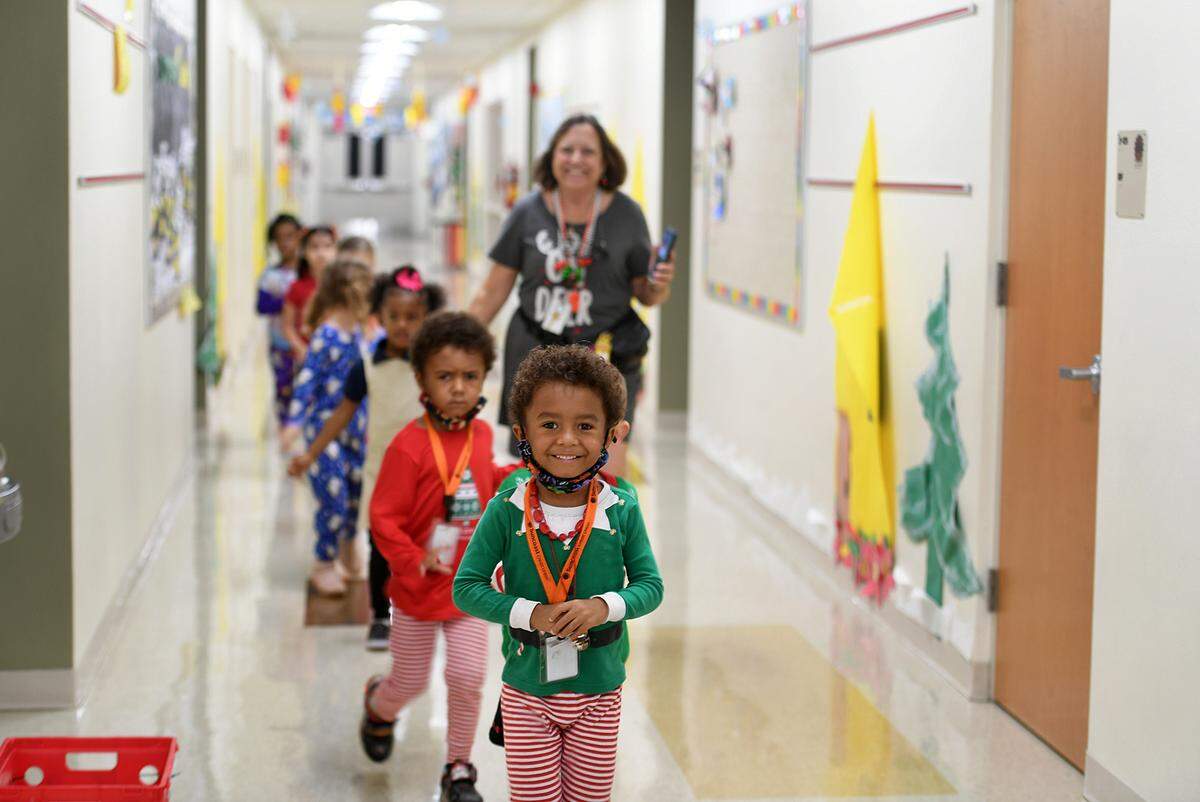 12/20/21—Sharon Harrison’s class walks in line to greet Santa, who arrived on an East Manatee Fire Rescue truck at Bashaw Elementary School.
