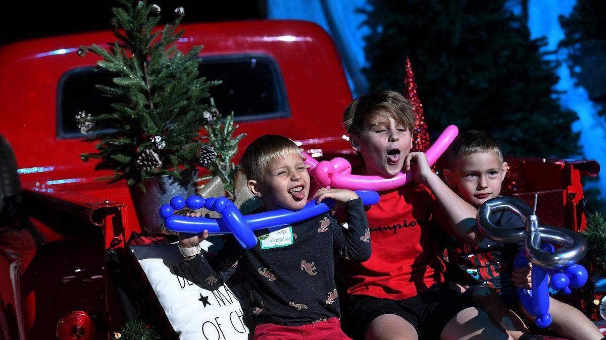 Jeremiah, Bentley and Elijah McIntyre, 5, 11 and 5, challenge their mother’s attempts for a photo she likes at the 37th annual Flight to the North Pole program for children with disabilities and terminal illness and their families. The event was founded by Sidney Ettedgui of the Manatee County Sheriff’s Office and Eastern Airline Flight attendants with the help of the Sarasota/Bradenton Airport Fire Dept. and Feld Entertainment.