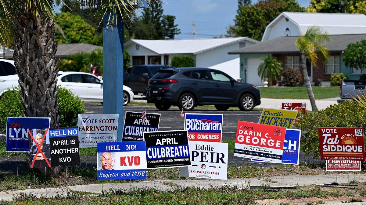 Campaign signs fill the public right-of-way in front of Redeemer Lutheran Church, Precinct 311, on primary election day.