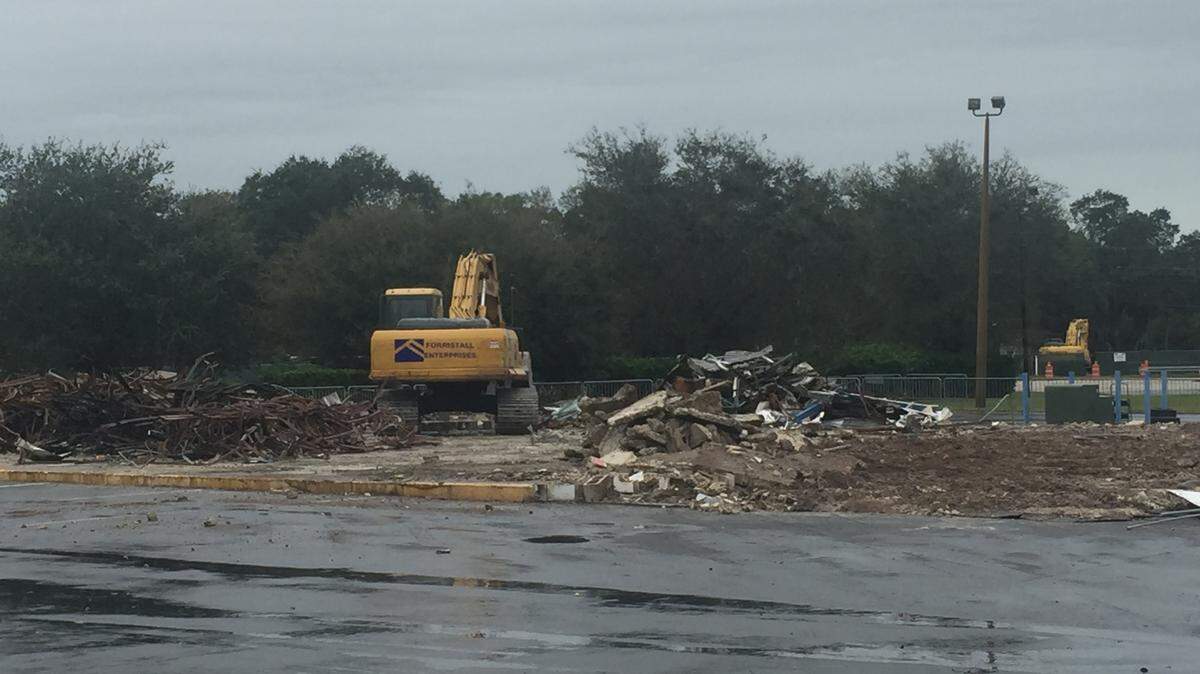 Crews remove the debris after the demolition of the former ABC Liquor building. Manatee County tax collector's office will expand into a new building on this site. 
 CLAIRE ARONSON/Bradenton Herald
