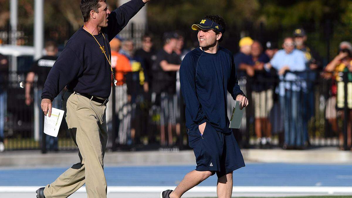 Michigan head coach Jim Harbaugh waves to fans who were loudly cheering before Friday's practice at IMG Academies which was open to the public. 
 TIFFANY TOMPKINS/Bradenton Herald