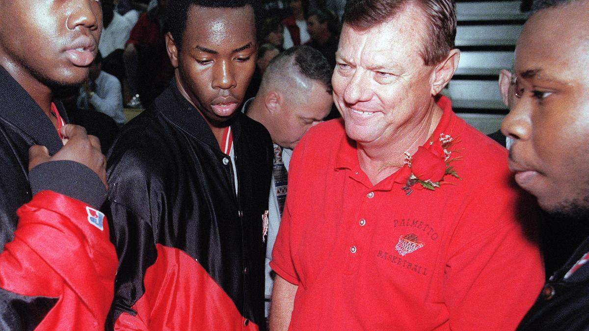 (RMB- 1/21/99) Members of the Palmetto Tigers varsity basketball team rally around their coach, Butch Hughes in Palmetto's newly dedicated gym in his honor. Staff Photo/ Richard M. Brooks
