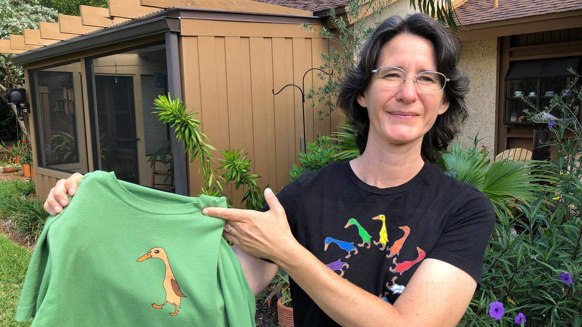 06/10/2021--Connie Wolgast wears her Proud Duck T-shirt design, and displays one of her Odd Duck T-shirts. The Proud Duck T-shirt celebrates Pride Month.