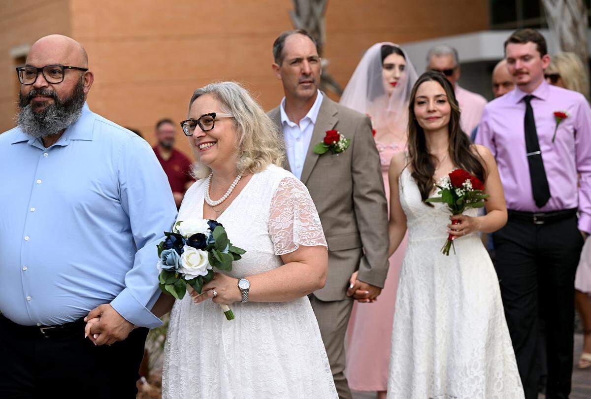 Couples walk to their places at the Fifth Annual Valentine’s Day Group Wedding.