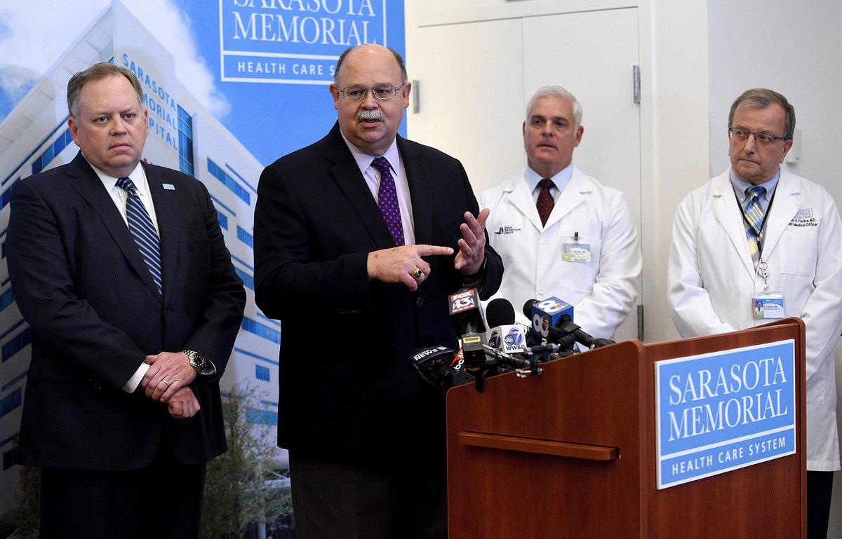 At a press conference held at Sarasota Memorial Hospital, Sarasota Dept. of Health Administrator Chuck Henry, at podium, reiterates that COVID-19 is a very serious illness. On left, SMH CEO David Verinder and Dr. Jack Rodman and Dr. James Fiorica stand with Henry.