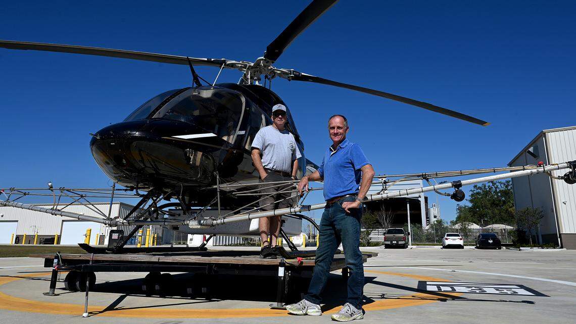 Chief pilot Mike McCraw and Dir. Chris Lesser with Manatee County Mosquito Control and one of the helicopters used to spray malathion to kill mosquitos.