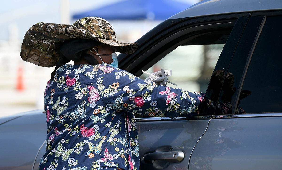 03/17/21--A health care worker administers a second dose of the COVID-19 vaccine at the Premier Sports Complex in Lakewood Ranch, which has been the center of controversy.