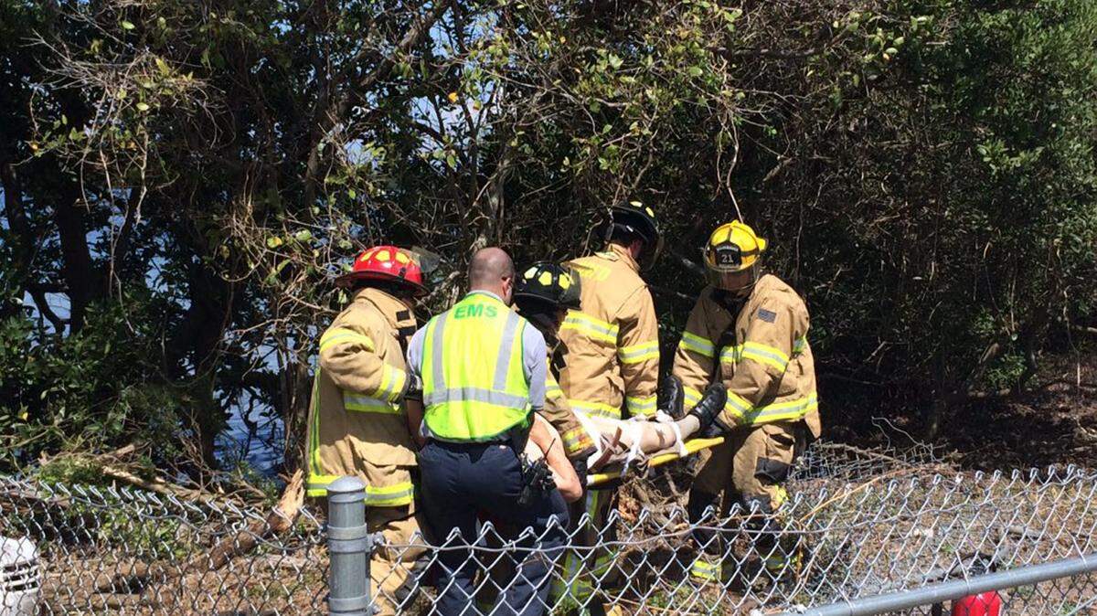 Firefighters lift a man involved in a rollover crash with injuries Wednesday afternoon.AMARIS CASTILLO/Bradenton Herald