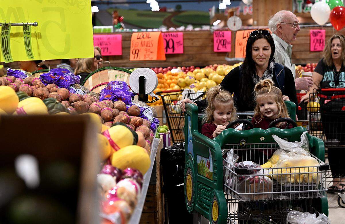 Customers peruse the produce in a crowded but festive atmosphere at the grand opening of the newest Detwiler’s Farm Market store in Bradenton.
