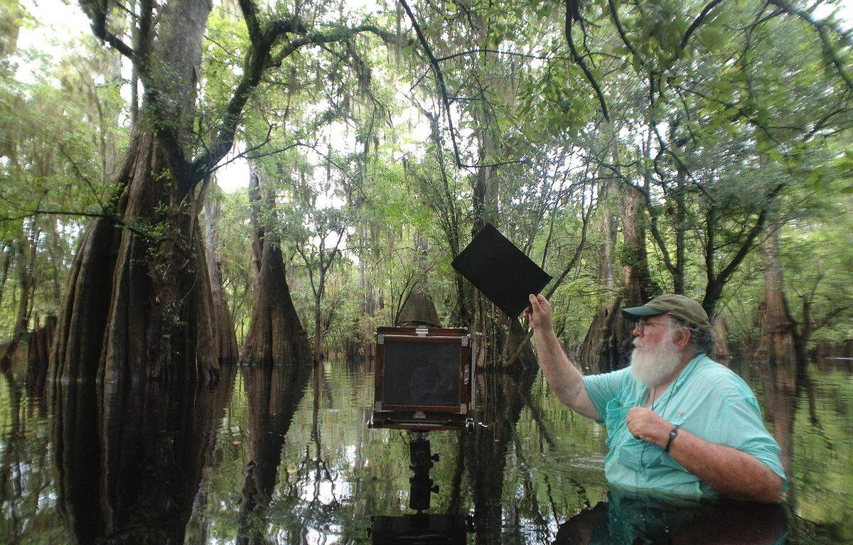 Clyde Butcher will go anywhere for a good photo, including wading into the Santa Fe River.