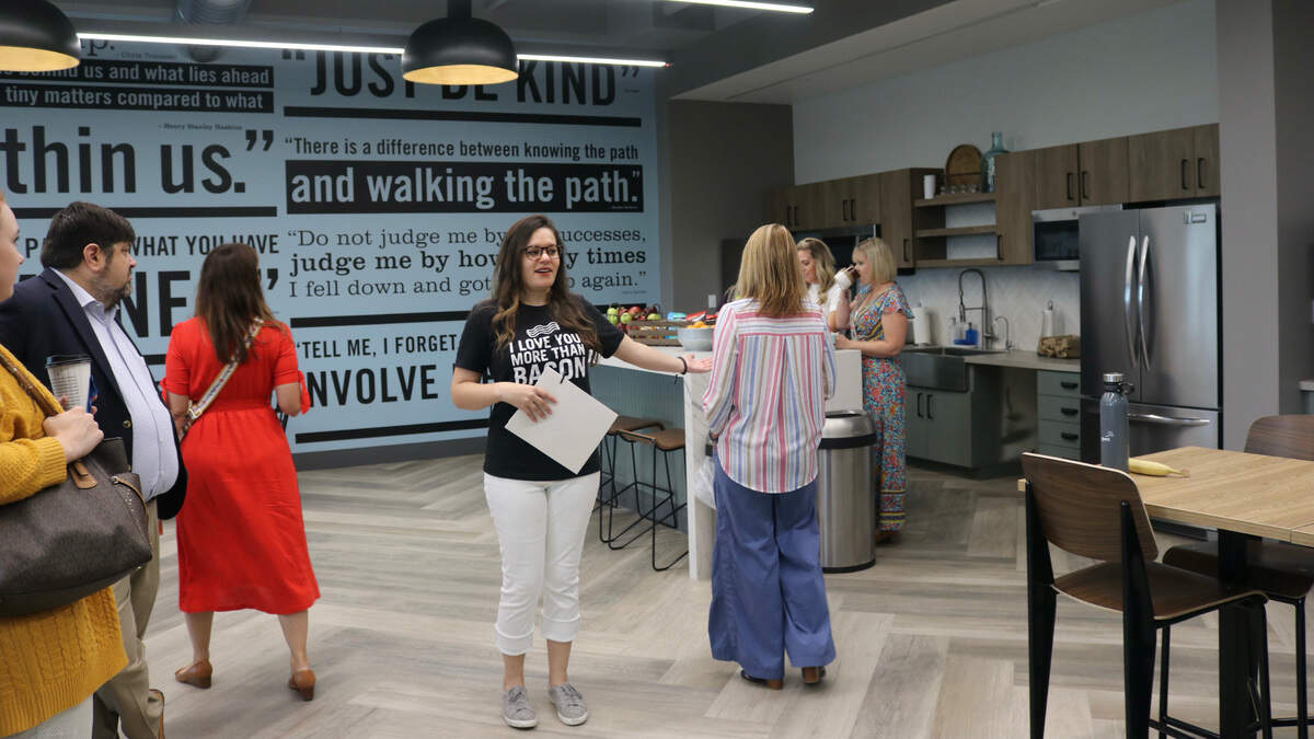 7/15/2021--First Watch restaurants christened the opening of its new corporate headquarters at 8725 Pendery Place, University Place, on Thursday, July 15. Eleni Kouvatsos, public relations & communications manager, shows guests around the new building.