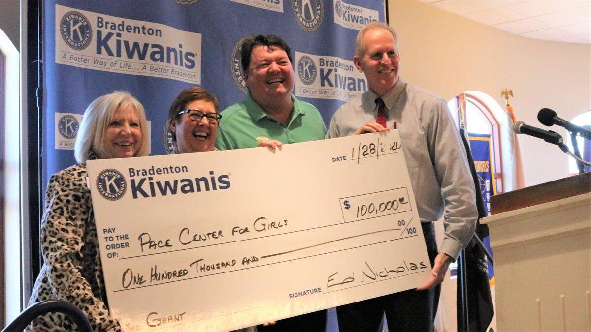 Accepting a $100,000 grant for Pace Center for Girls from the Bradenton Kiwanis Club on Tuesday were, from left, Sandy Groseclose, development manager, and Amanda and John Horne, fundraising co-chairs. Also shown is Judge Ed Nicholas.