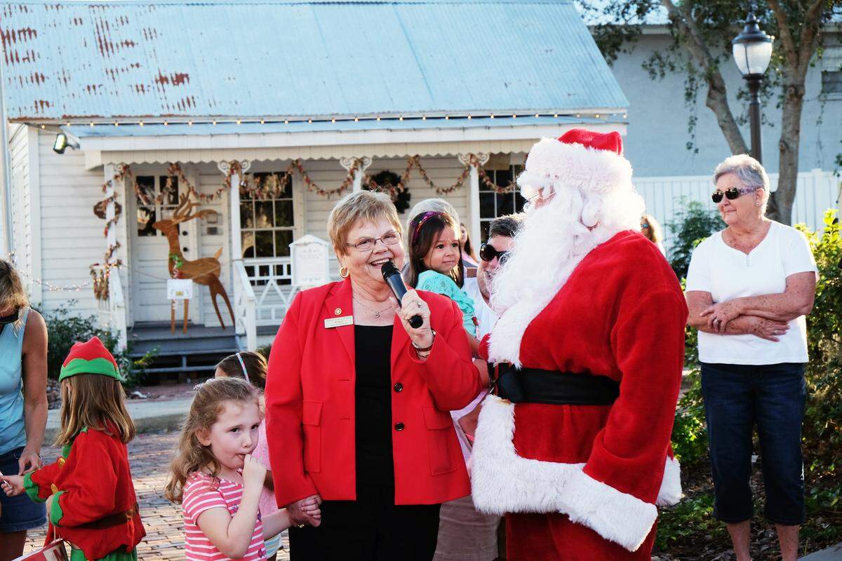 Palmetto Mayor Shirley Groover Bryant and her granddaughter, Emma, greet Santa at a past Christmas in the Park.
