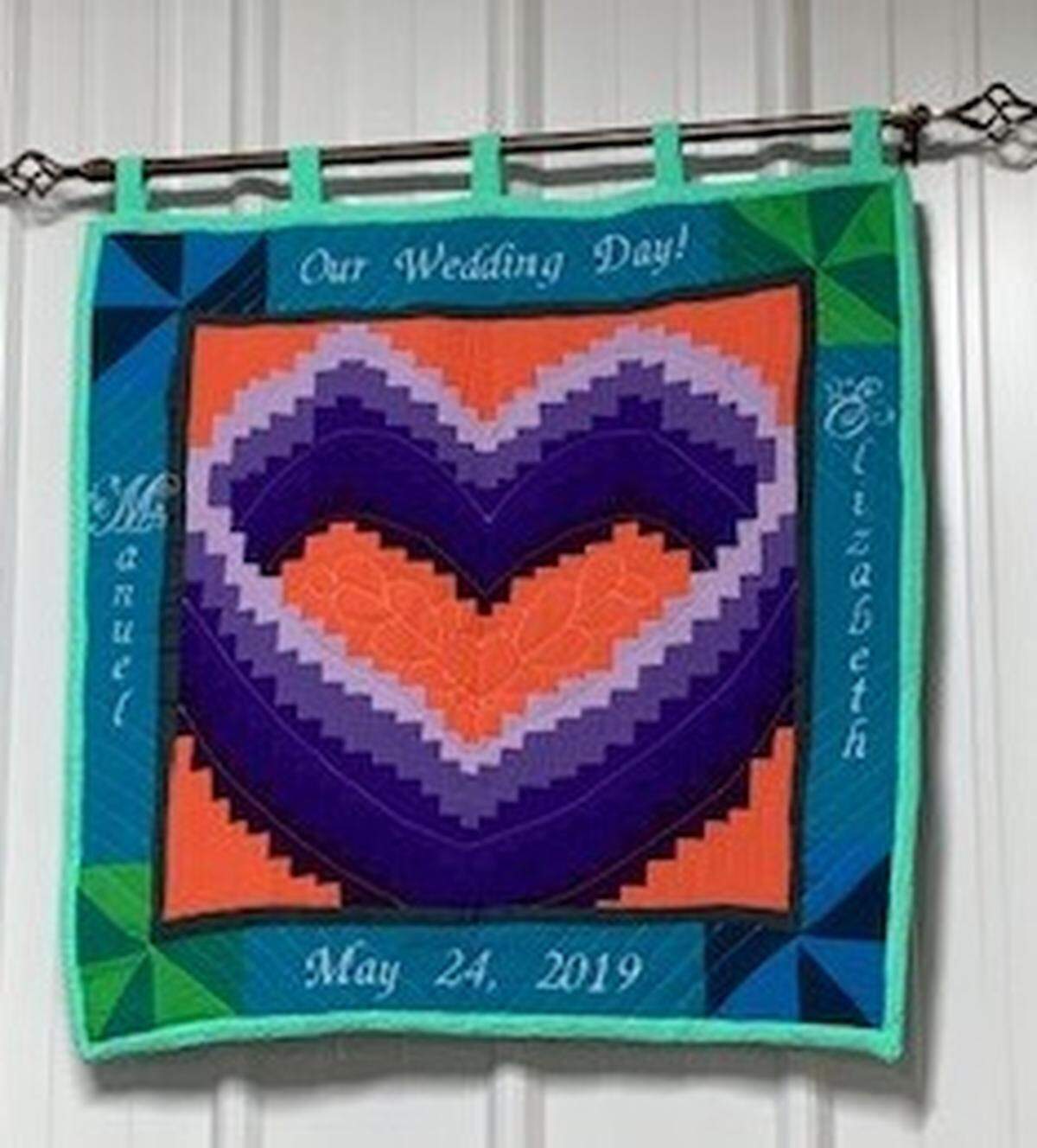 A lovely quilted wall hanging with Manuel and Elizabeth’s names greeted guests at the meal after the wedding ceremony.
